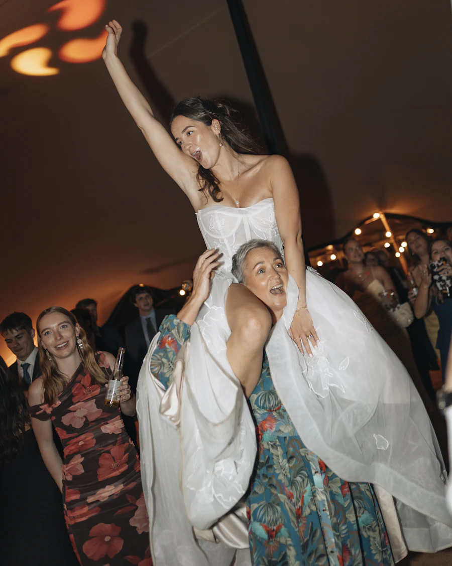 Bride lifted onto the guests' shoulders in the middle of the party